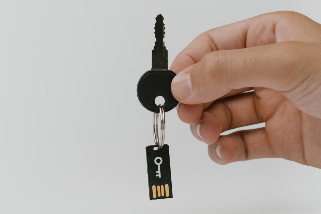 Hand Holding a Key With a USB Flash Drive