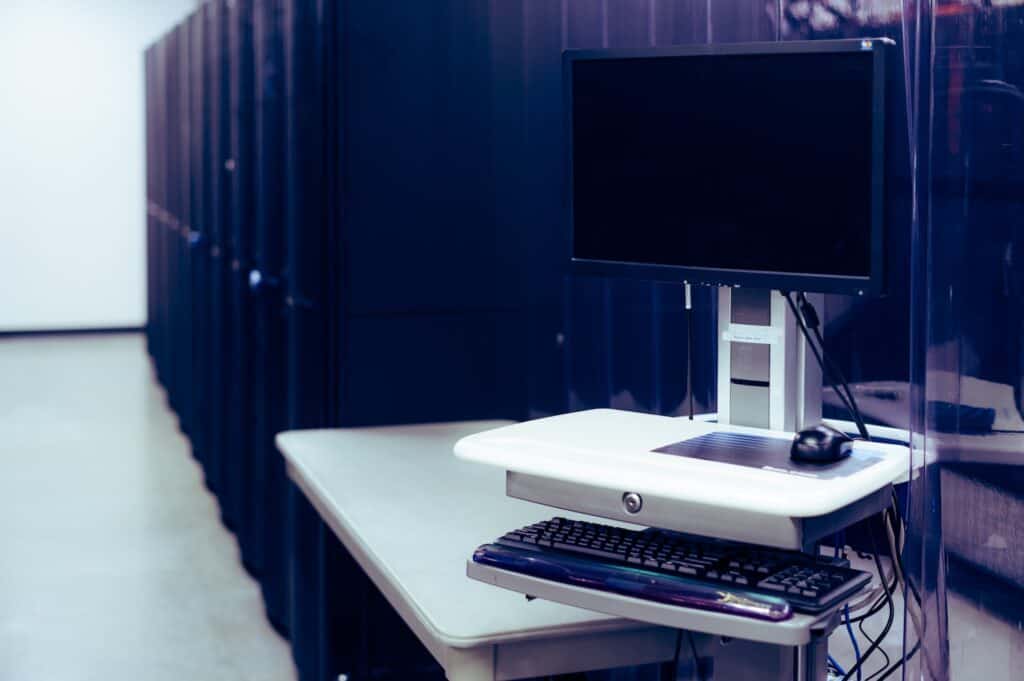 Modern Computer Placed near Server Racks 